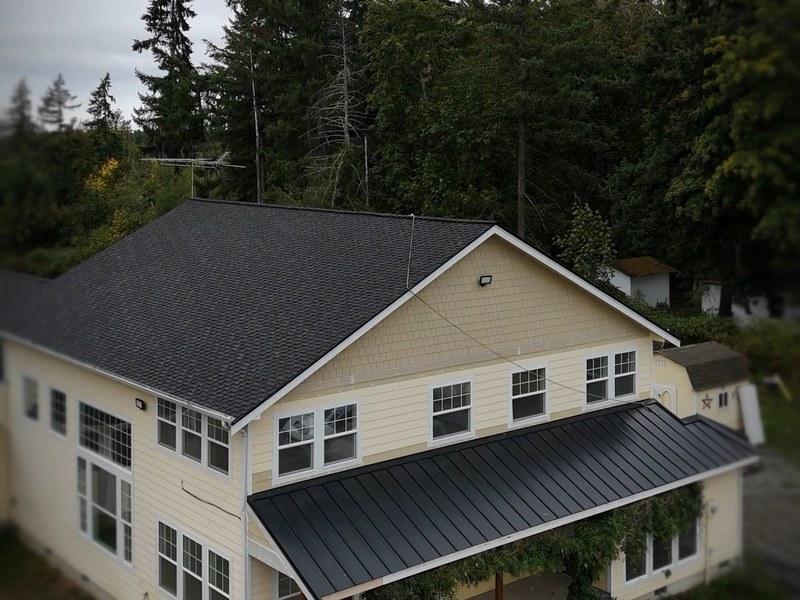 Drone view of a two story house with a dark shingle roof built by Corevia